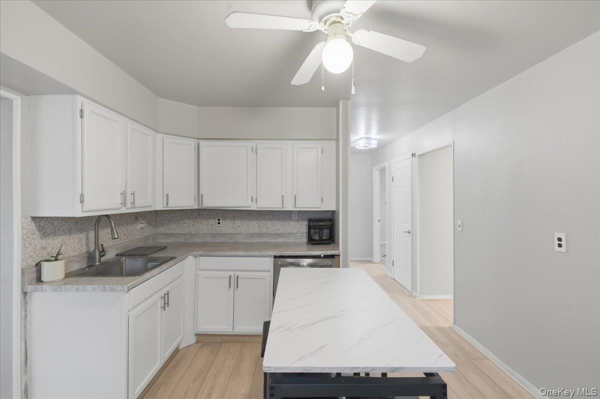 30 George Drive Mastic, NY 11950 - Photo 9 of 26 a kitchen with a sink cabinets and window