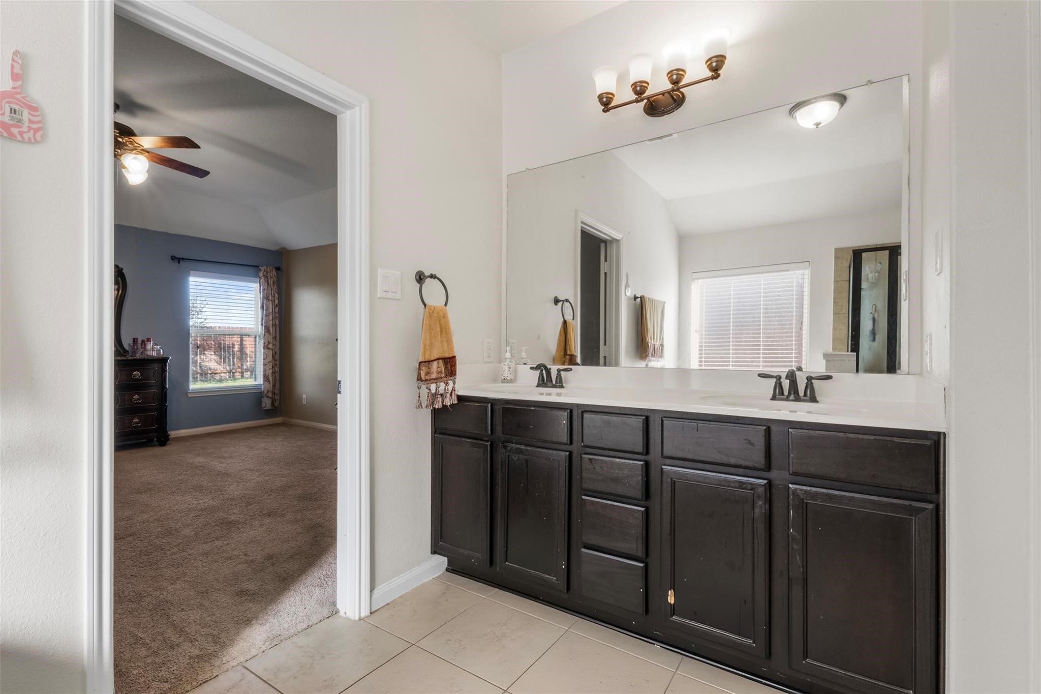 22907 Gentle Shadow Drive Hockley, TX 77447 - Photo 13 of 27 a spacious bathroom with a double vanity sink and a mirror