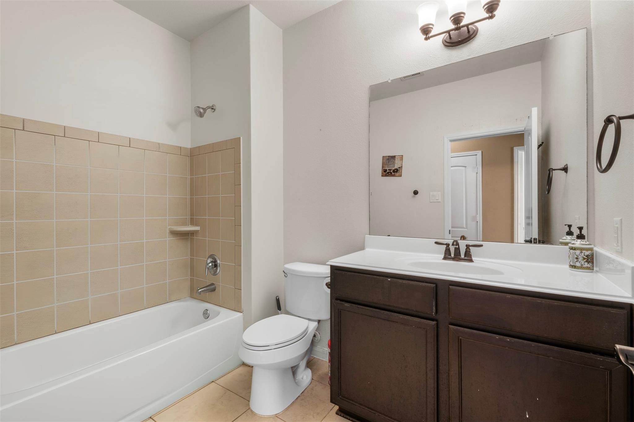 22907 Gentle Shadow Drive Hockley, TX 77447 - Photo 20 of 27 a bathroom with a bathtub shower sink vanity mirror and toilet