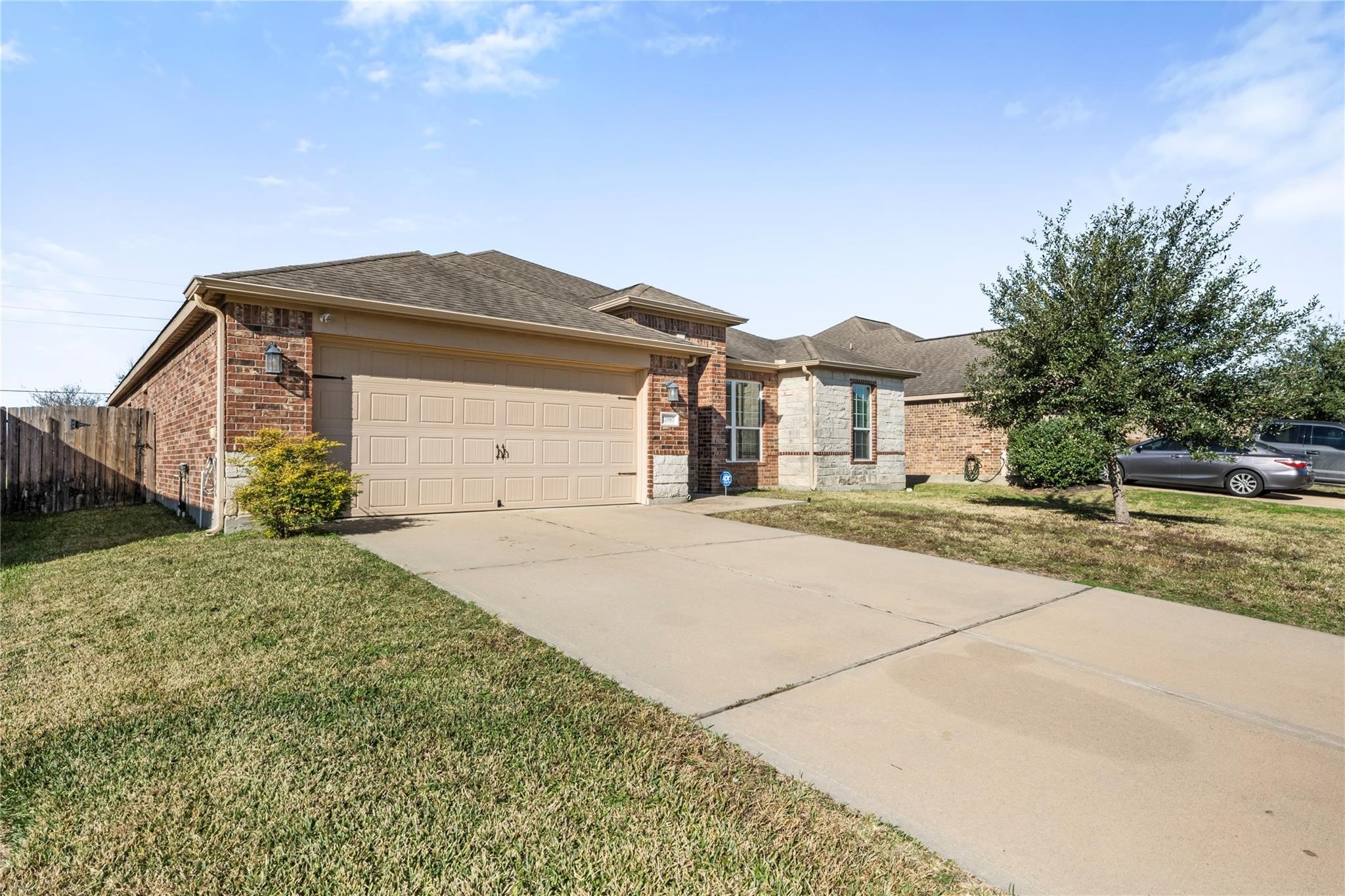 22907 Gentle Shadow Drive Hockley, TX 77447 - Photo 4 of 27 a front view of a house with a yard and garage