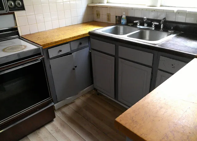 a kitchen with a sink and cabinets