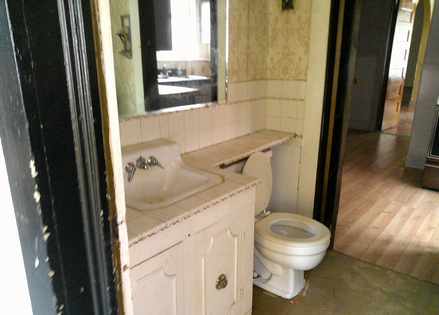 958 West William Street Decatur, IL 62522 - Photo 9 of 20 a white toilet sitting next to a bathroom sink
