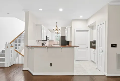 a kitchen with stainless steel appliances white cabinets and a sink