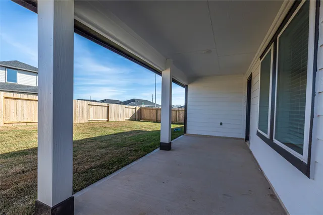 a view of an empty room with floor to ceiling windows
