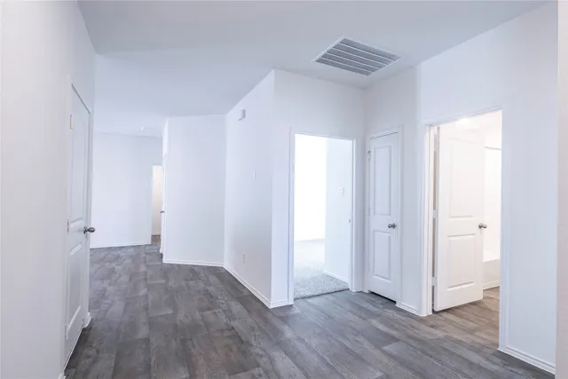 a view of hallway with wooden floor