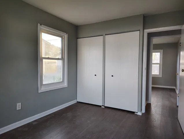 a bathroom with a window sink and mirror