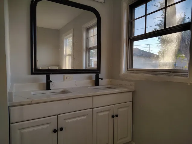 a bathroom with a sink a toilet and mirror