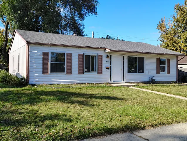 a kitchen with granite countertop a sink cabinets and stainless steel appliances