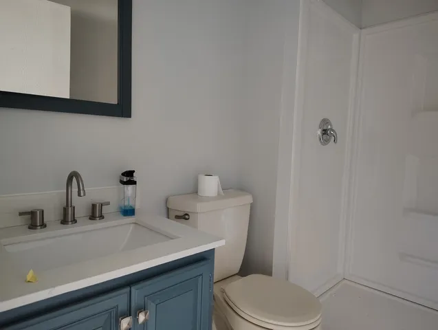 a view of an empty room and bathroom view