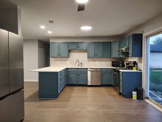 a kitchen with a stove a sink and a refrigerator