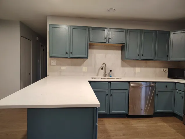 a kitchen with a sink and a stove top oven