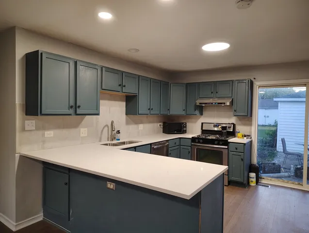 a kitchen with a sink and a refrigerator