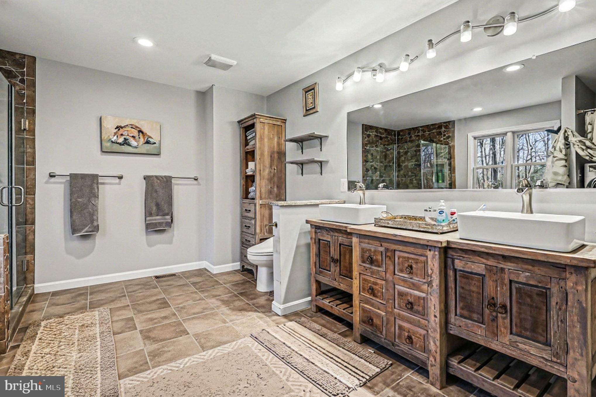 8318 Diamond Hill Road Warrenton, VA 20186 - Photo 14 of 88 a spacious bathroom with a double vanity sink a large mirror and a bathtub