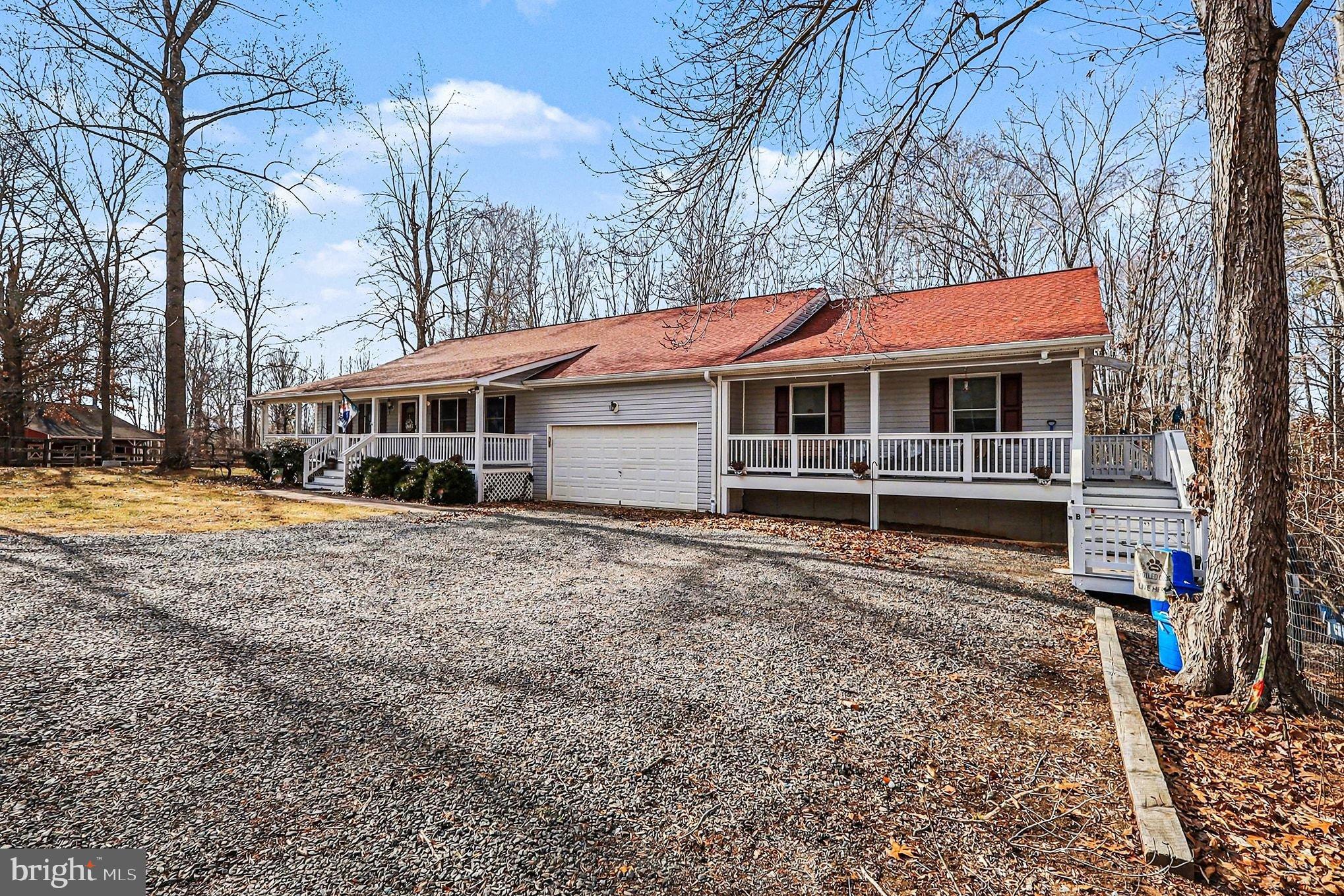 8318 Diamond Hill Road Warrenton, VA 20186 - Photo 2 of 88 a front view of a house with a yard table and chairs
