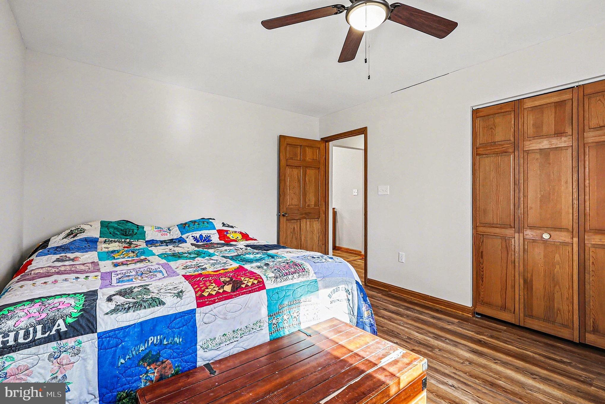 8318 Diamond Hill Road Warrenton, VA 20186 - Photo 30 of 88 a bedroom with a bed and wooden floor