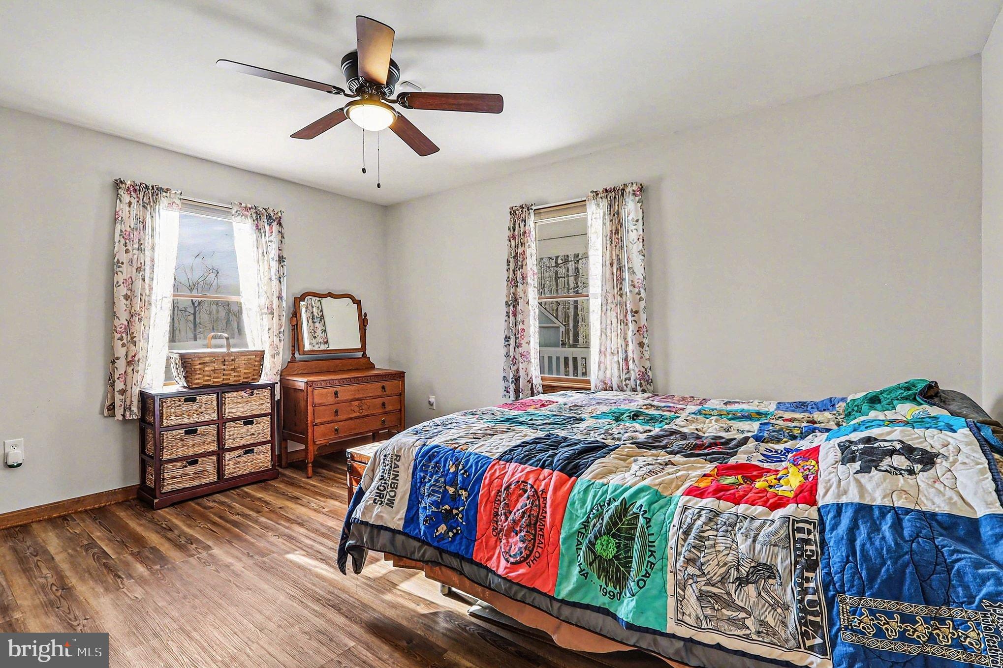 8318 Diamond Hill Road Warrenton, VA 20186 - Photo 31 of 88 a bedroom with a bed and wooden floor