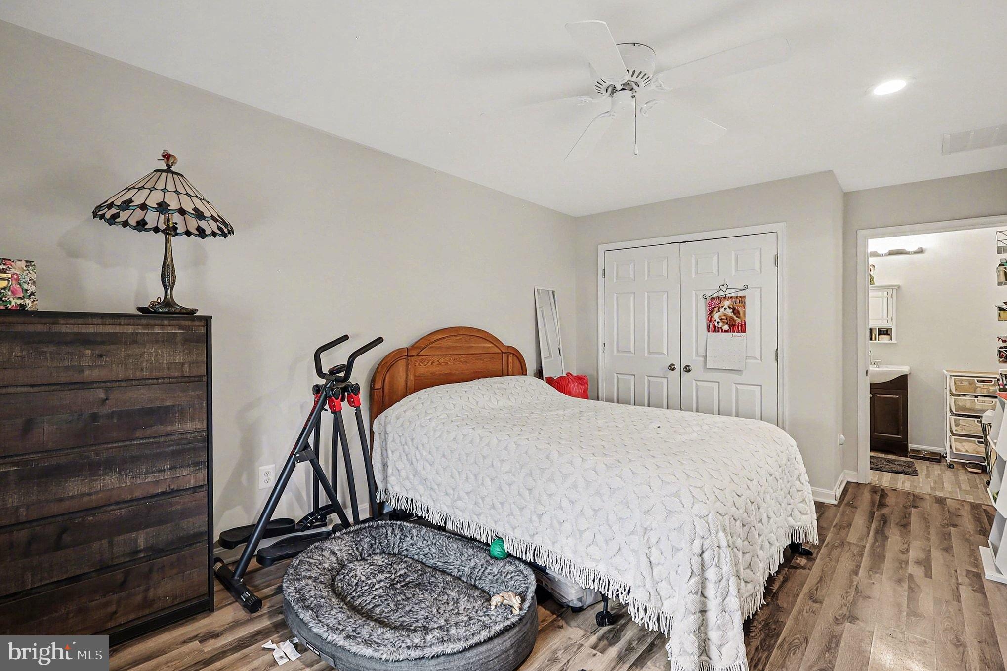 8318 Diamond Hill Road Warrenton, VA 20186 - Photo 33 of 88 a bedroom with a bed and a chandelier