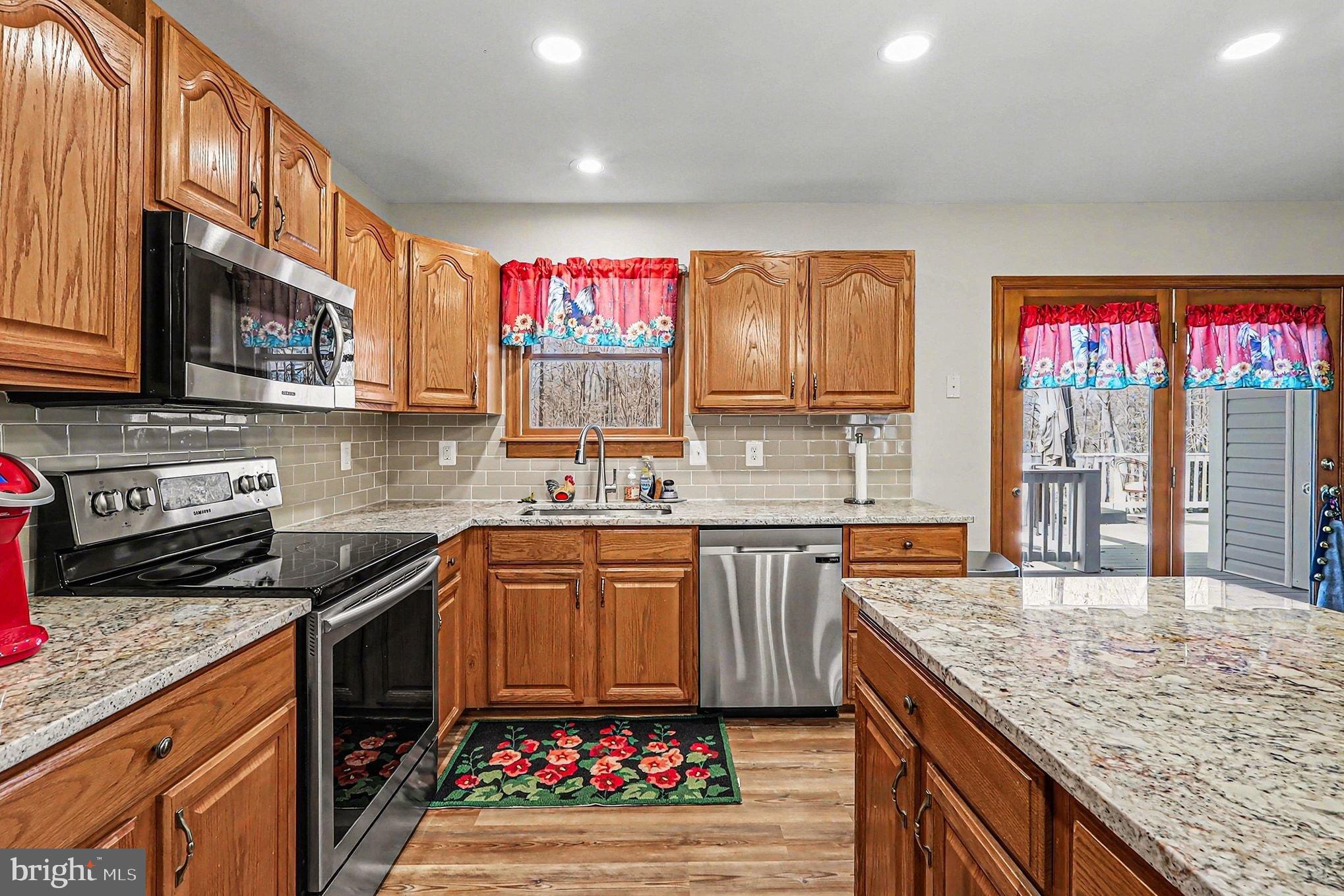 8318 Diamond Hill Road Warrenton, VA 20186 - Photo 7 of 88 a kitchen with stainless steel appliances granite countertop a sink stove and cabinets