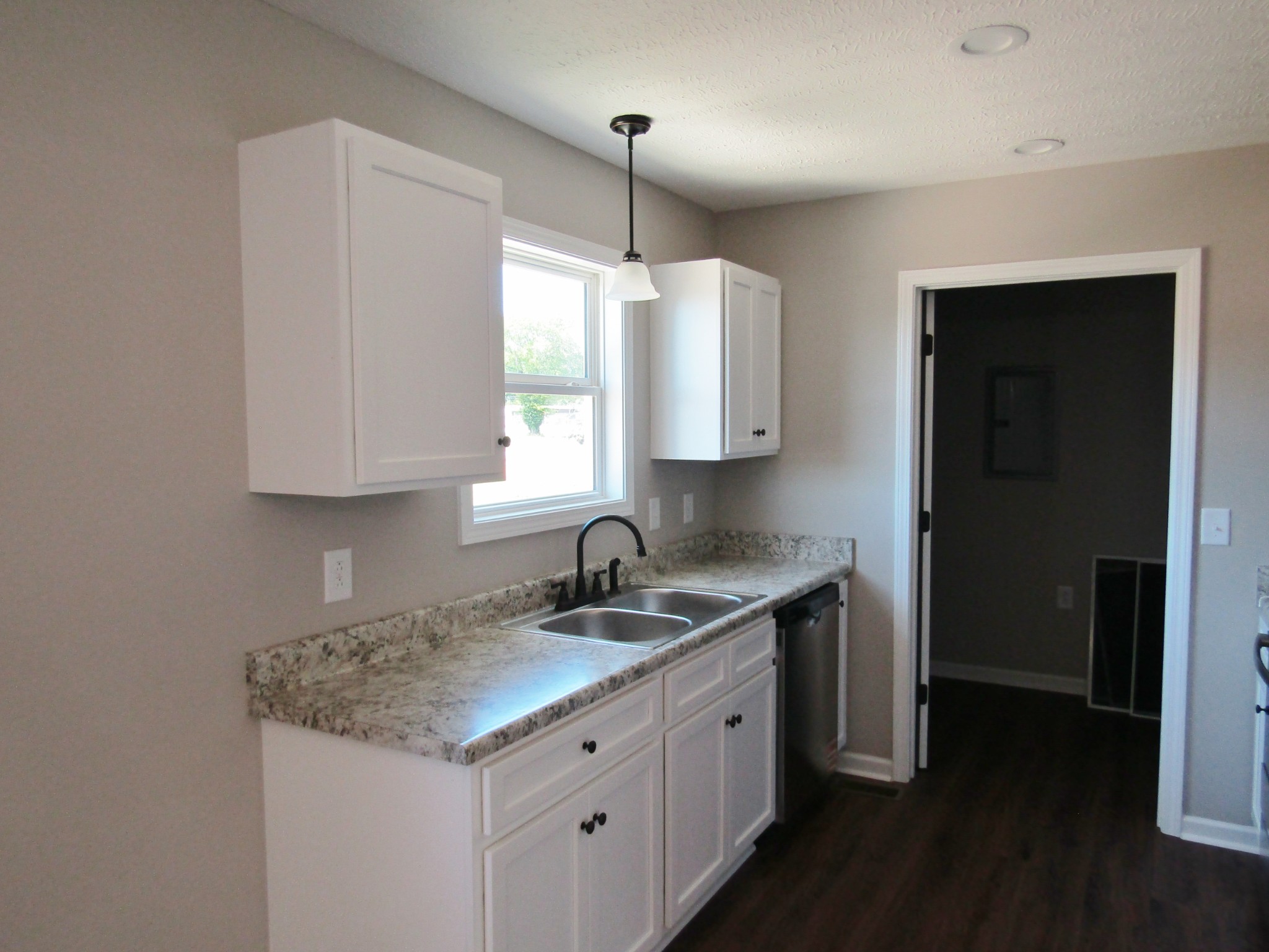 480 Crescent Factory Road Lawrenceburg, TN 38464 - Photo 7 of 14 a kitchen with granite countertop a sink and dishwasher with wooden floor