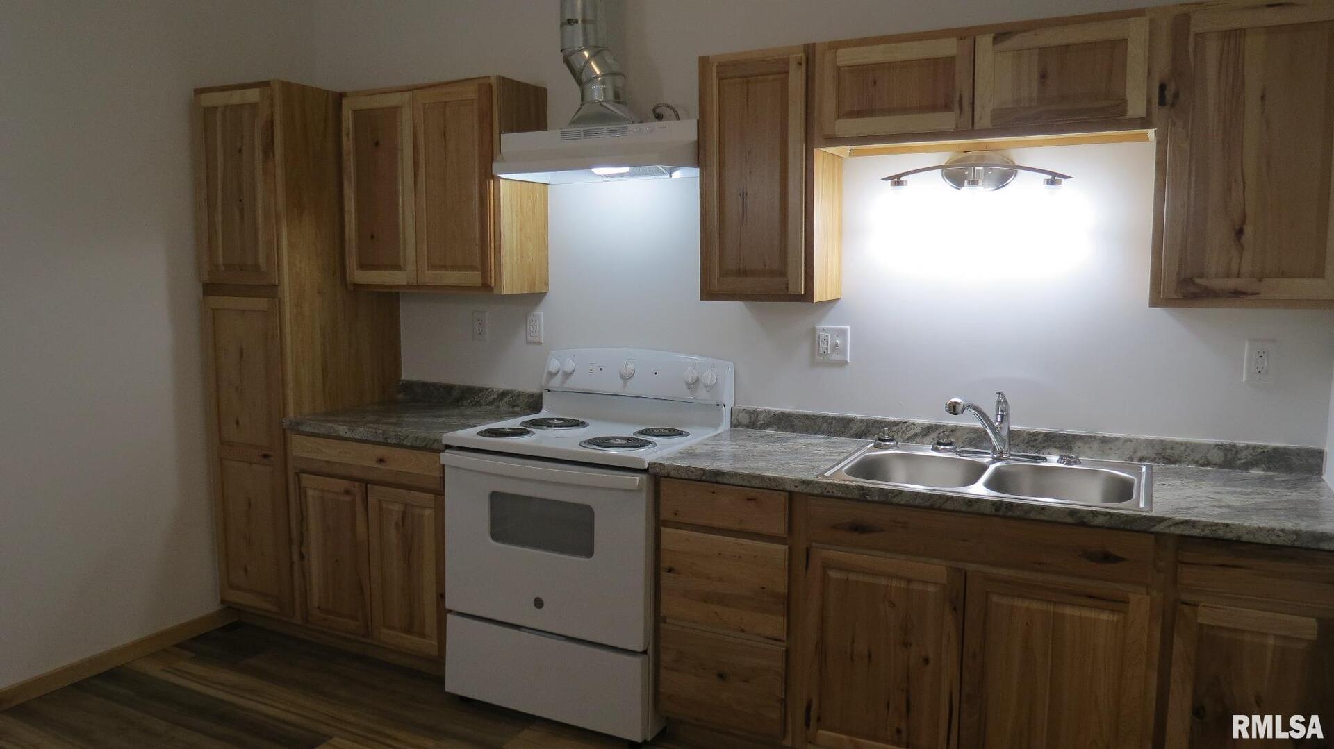 12 North Division Street Du Quoin, IL 62832 - Photo 18 of 21 a kitchen with stainless steel appliances granite countertop a sink stove and refrigerator