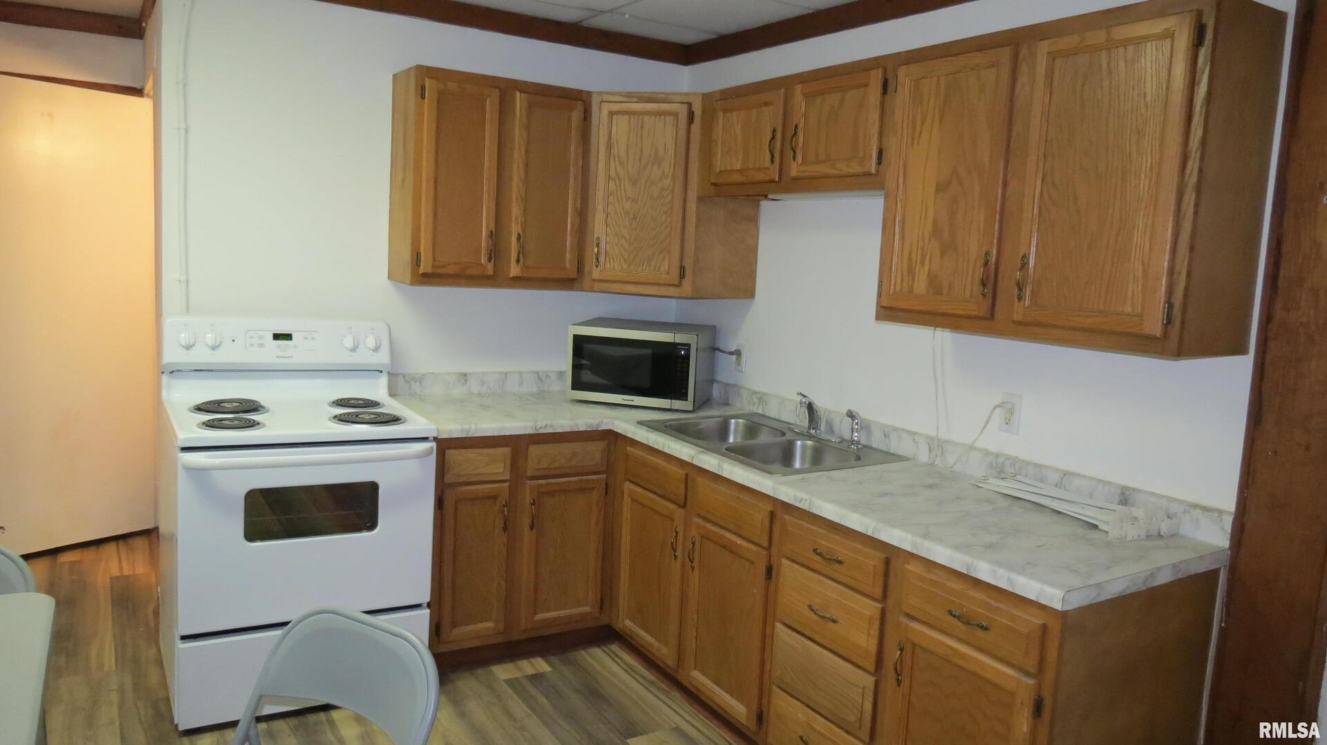 12 North Division Street Du Quoin, IL 62832 - Photo 5 of 21 a kitchen with a sink stove and cabinets