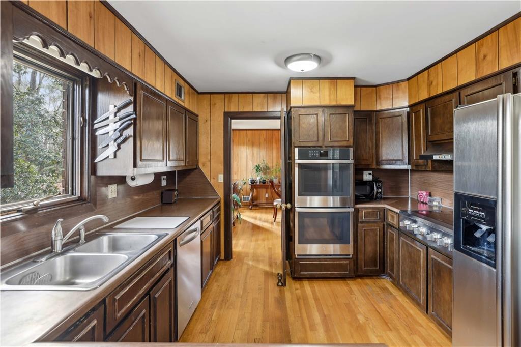 1605 Saint Tropez Way Atlanta, GA 30350 - Photo 14 of 29 a kitchen with stainless steel appliances a sink cabinets and a large window