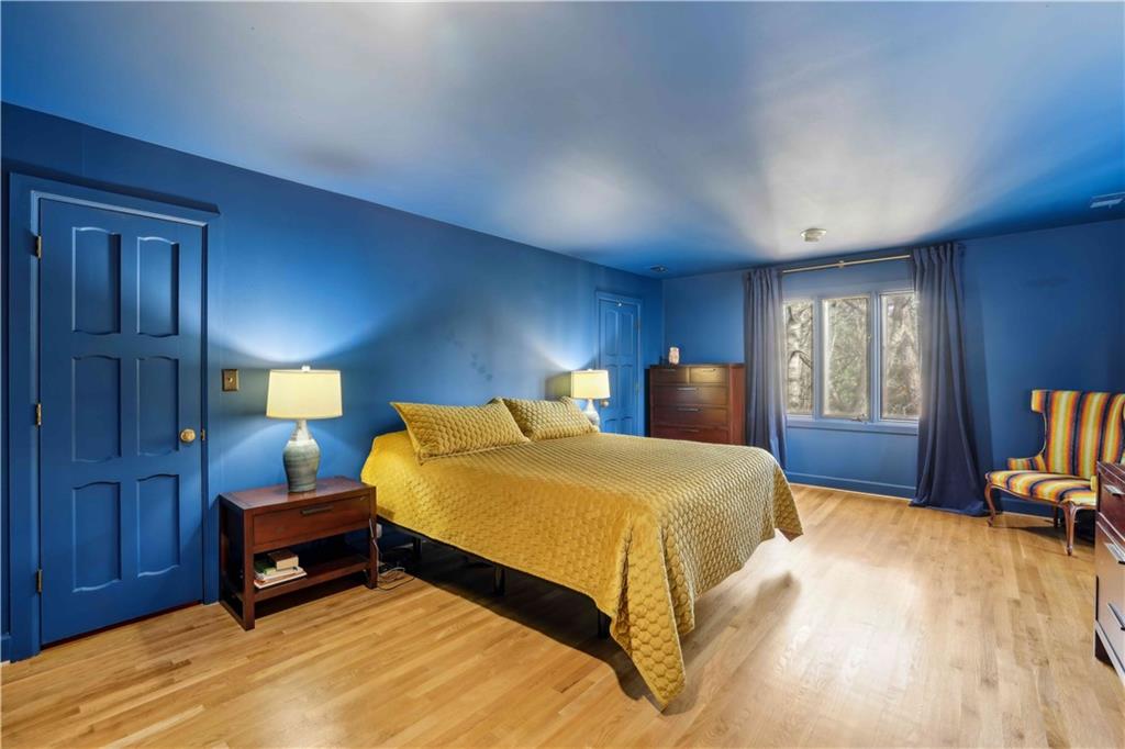 1605 Saint Tropez Way Atlanta, GA 30350 - Photo 19 of 29 a bedroom with a bed and wooden floor