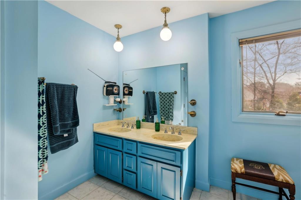 1605 Saint Tropez Way Atlanta, GA 30350 - Photo 20 of 29 a spacious bathroom with a double vanity sink and a mirror