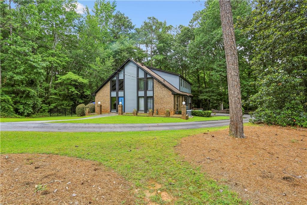 1605 Saint Tropez Way Atlanta, GA 30350 - Photo 2 of 29 a view of a house with a yard