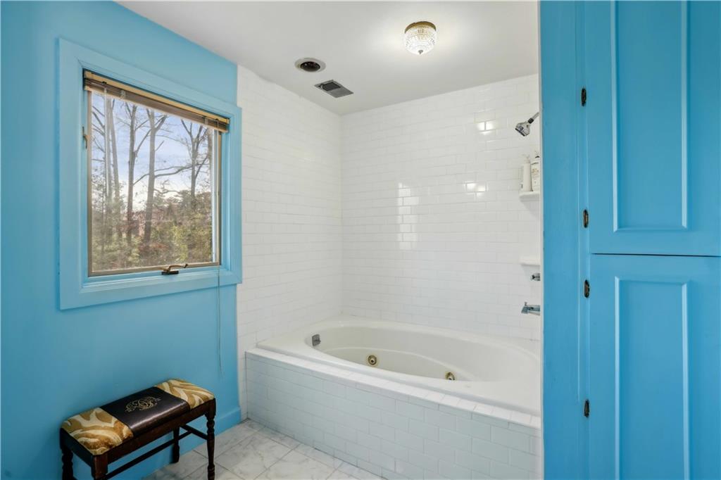 1605 Saint Tropez Way Atlanta, GA 30350 - Photo 21 of 29 a bathroom with a tub shower and window