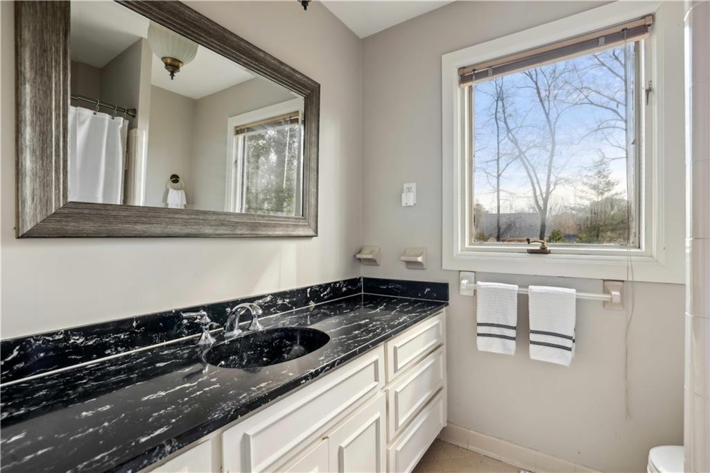 1605 Saint Tropez Way Atlanta, GA 30350 - Photo 24 of 29 a kitchen with granite countertop a stove and a sink