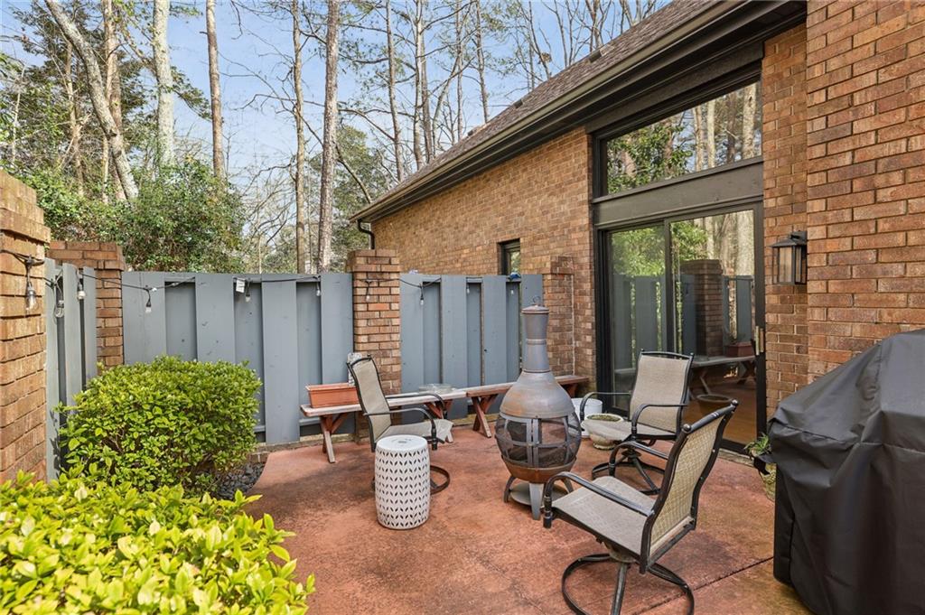 1605 Saint Tropez Way Atlanta, GA 30350 - Photo 27 of 29 a view of a patio with table and chairs and potted plants