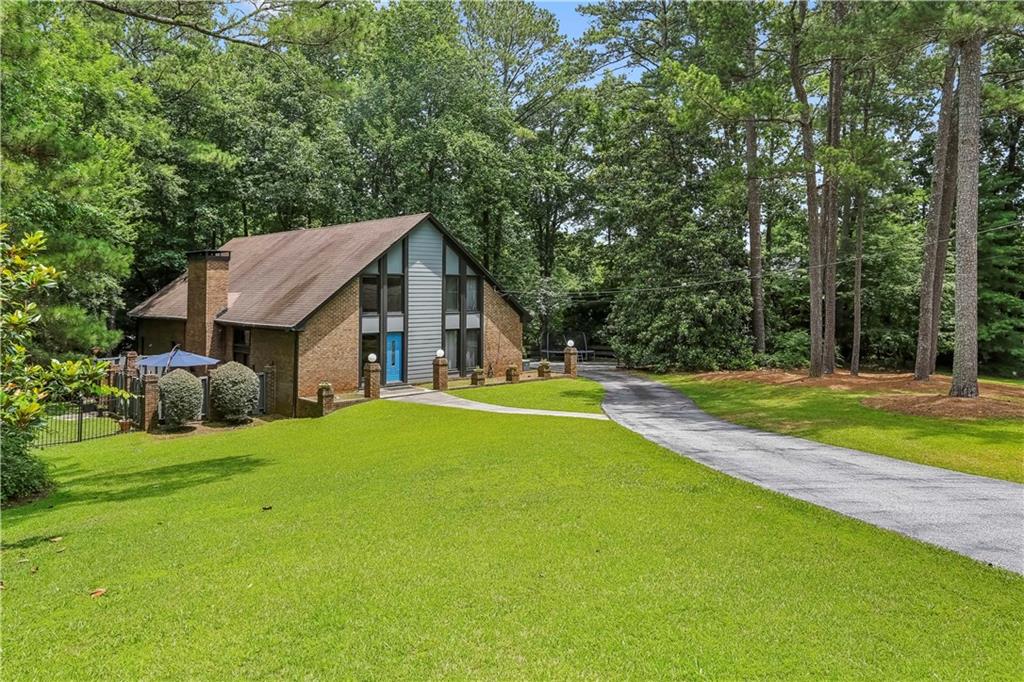 1605 Saint Tropez Way Atlanta, GA 30350 - Photo 3 of 29 a view of house that has a big yard