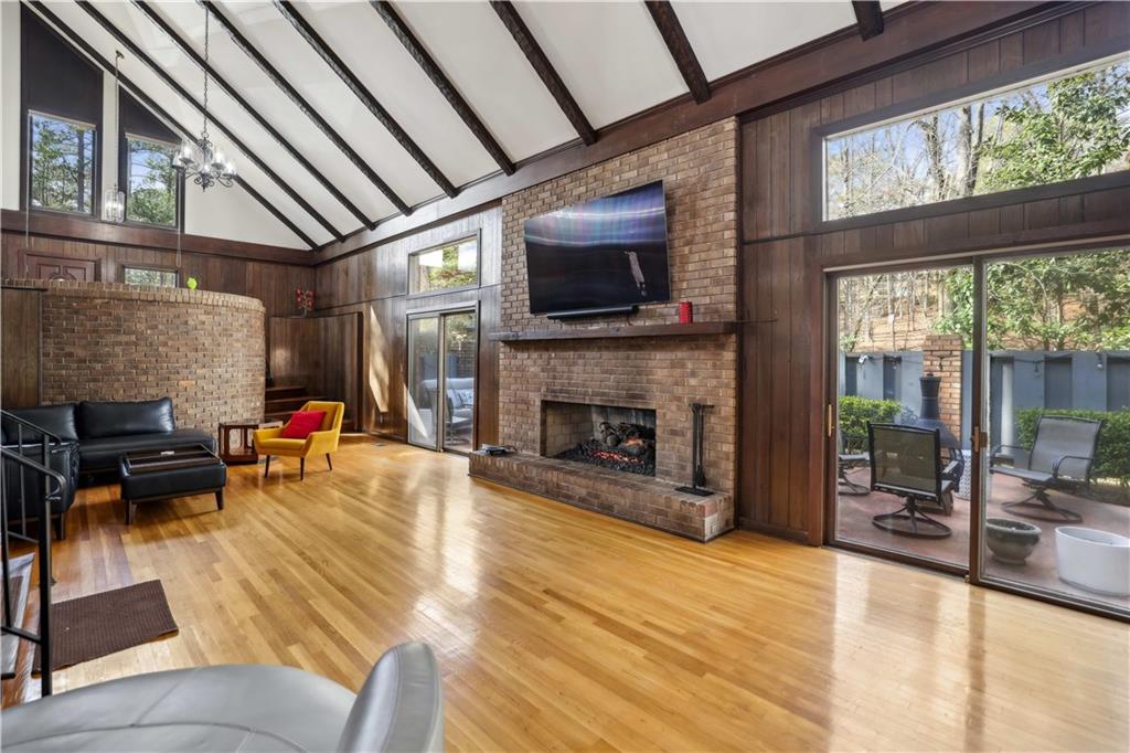 1605 Saint Tropez Way Atlanta, GA 30350 - Photo 7 of 29 a living room with furniture a fireplace and a flat screen tv