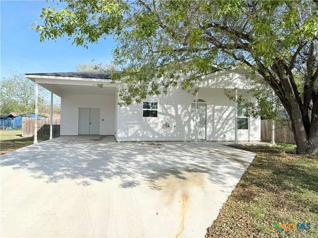 a view of a house with a yard and garage