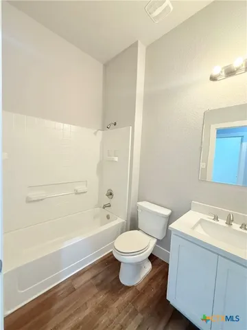 a bathroom with a granite countertop toilet a sink and bathtub