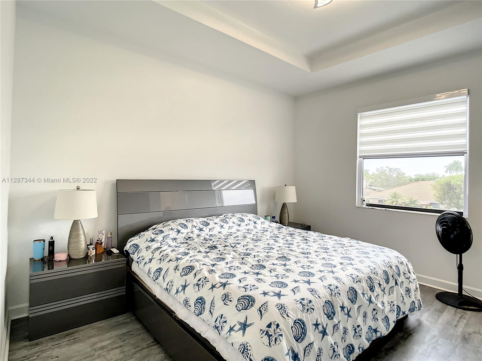 18272 Southwest 148th Road, Unit 18272 Miami, FL 33187 - Photo 13 of 19 a bedroom with a bed and a window