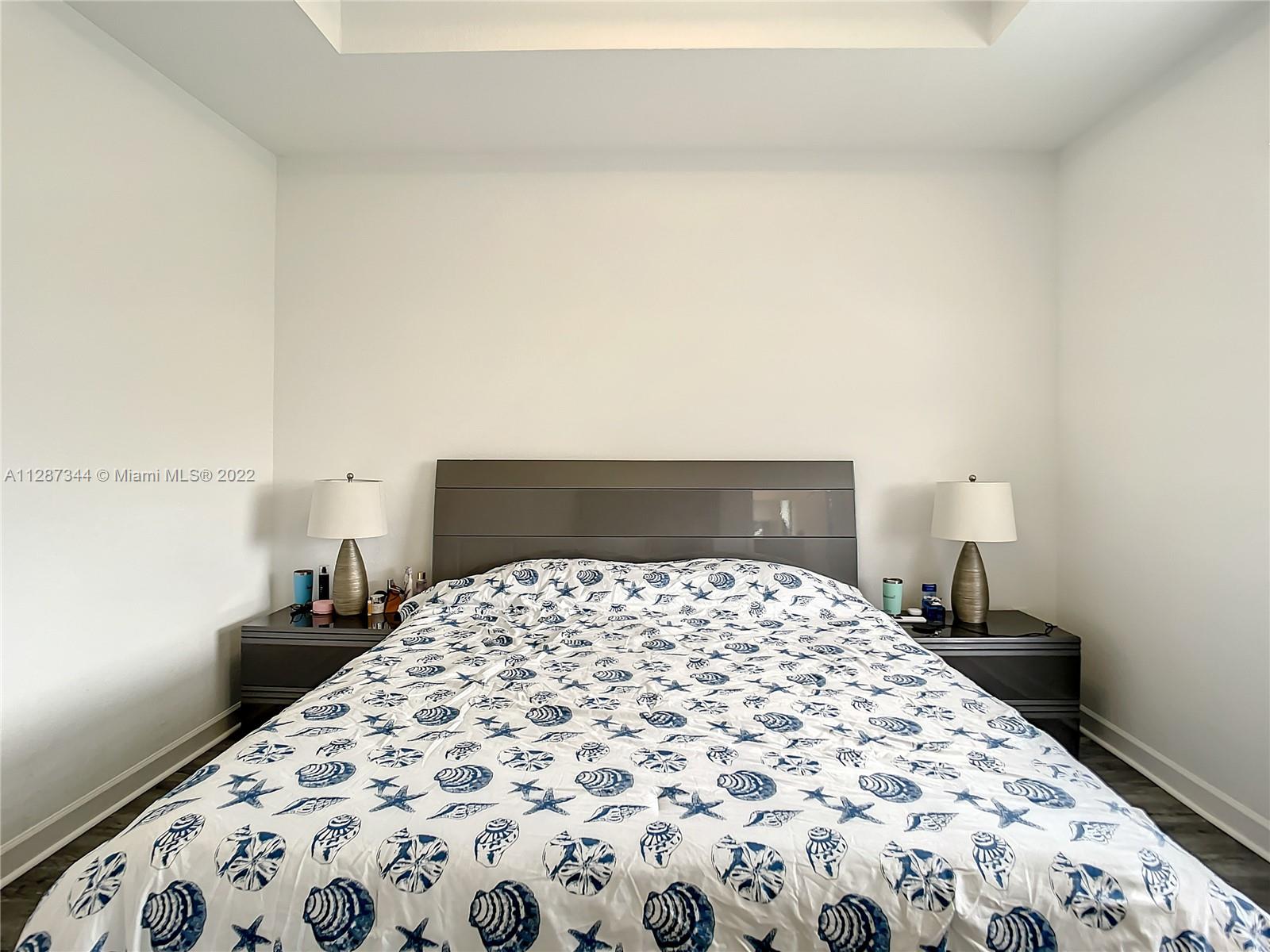 18272 Southwest 148th Road, Unit 18272 Miami, FL 33187 - Photo 14 of 19 a bedroom with a large bed and curtain