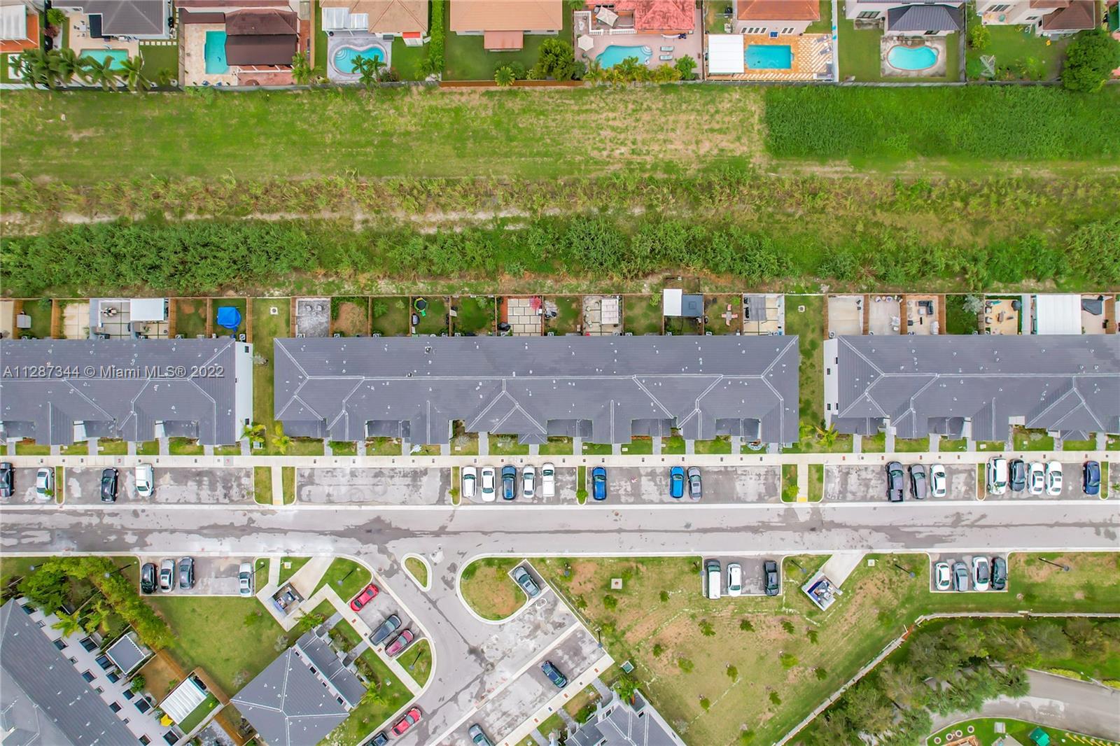 18272 Southwest 148th Road, Unit 18272 Miami, FL 33187 - Photo 19 of 19 a view of swimming pool with a yard and plants