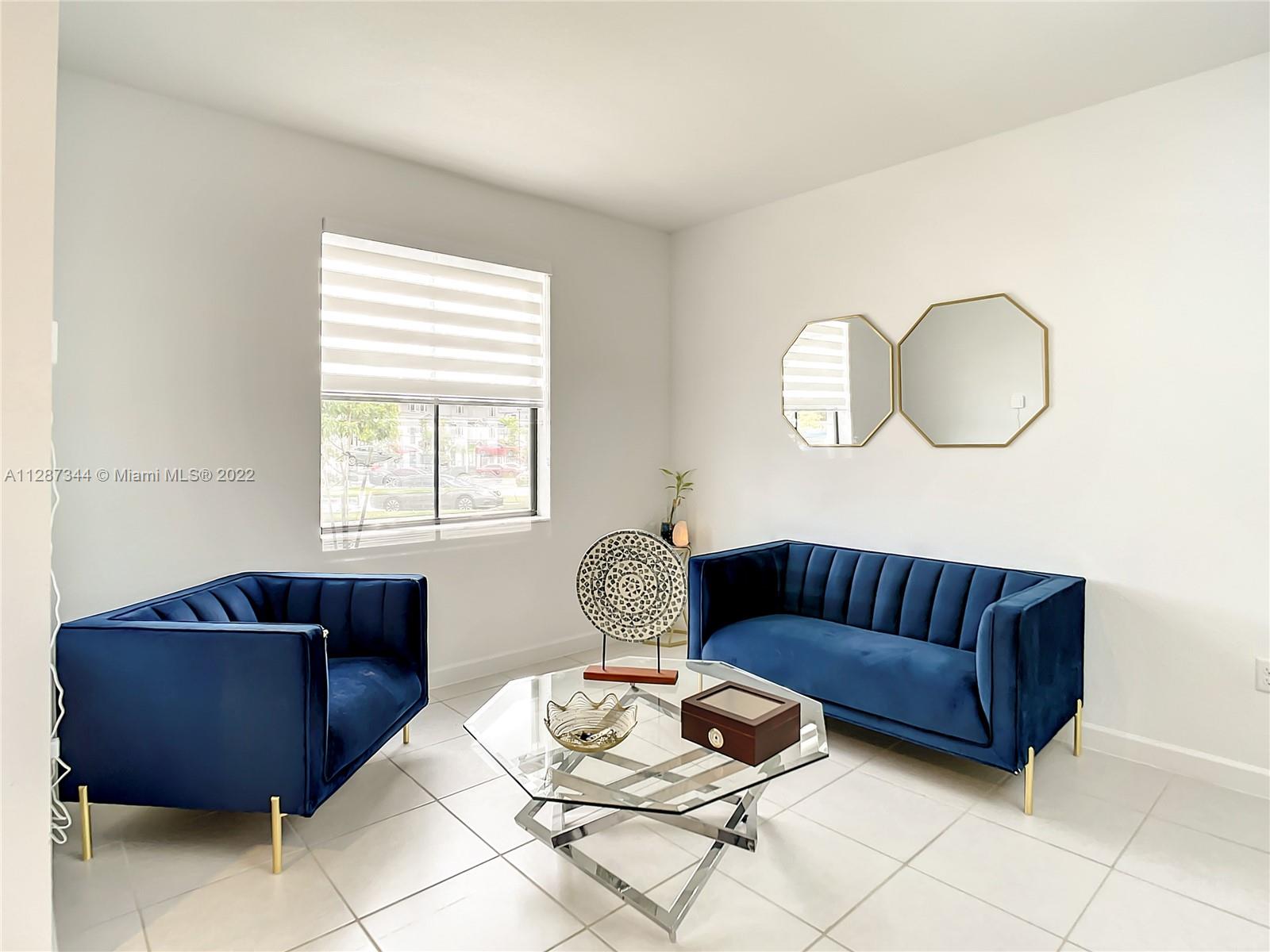 18272 Southwest 148th Road, Unit 18272 Miami, FL 33187 - Photo 3 of 19 a living room with furniture and a window