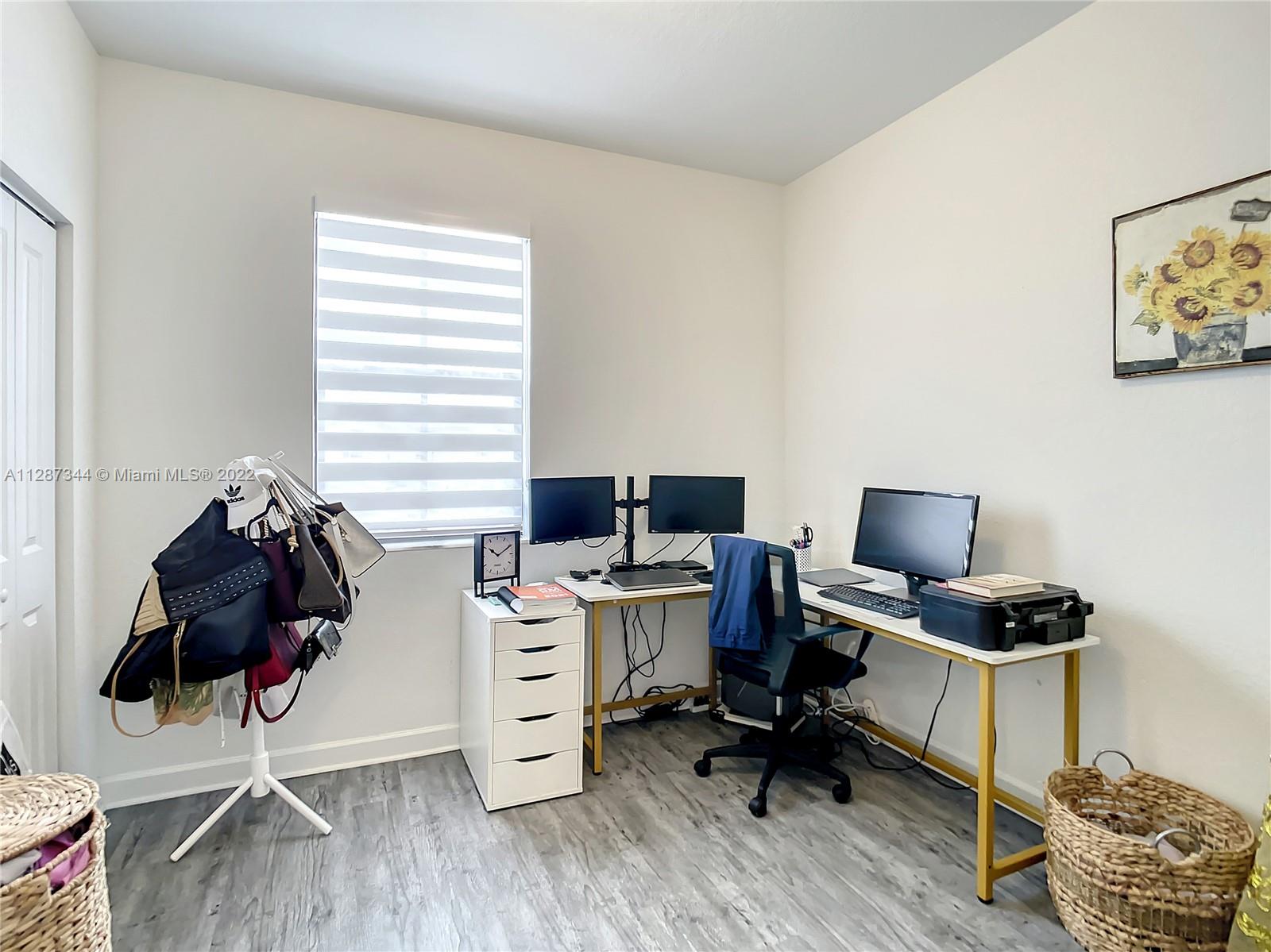 18272 Southwest 148th Road, Unit 18272 Miami, FL 33187 - Photo 10 of 19 a view of workspace with wooden floor windows