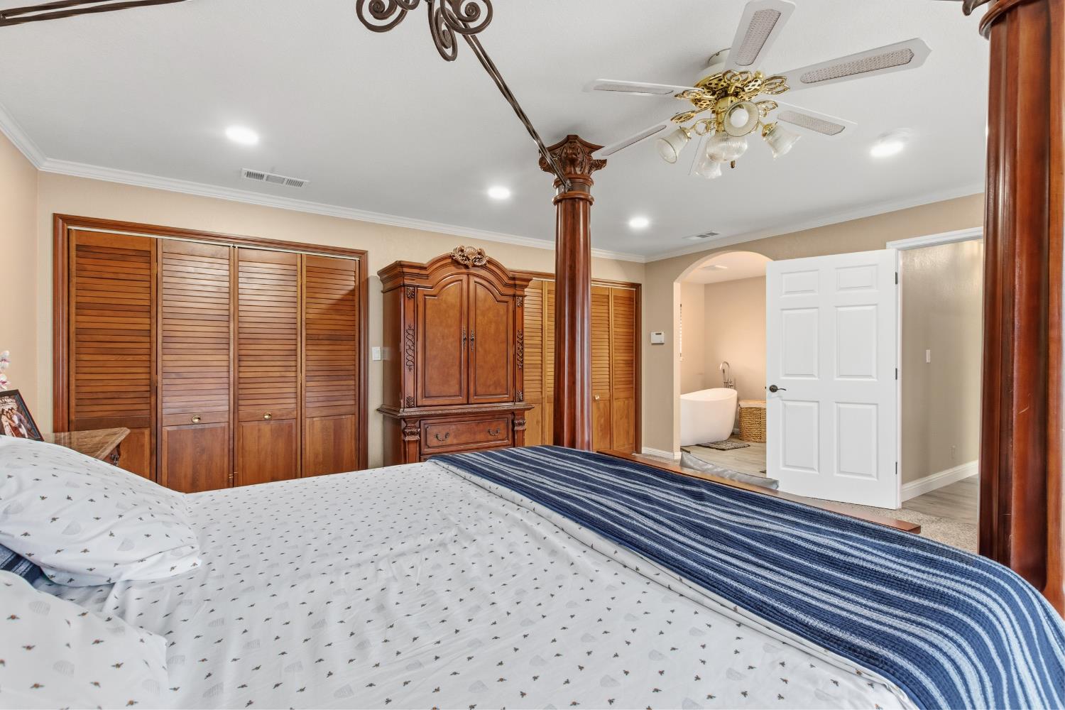 17188 Von Sosten Road Tracy, CA 95304 - Photo 26 of 39 a bedroom with a large bed and a chandelier