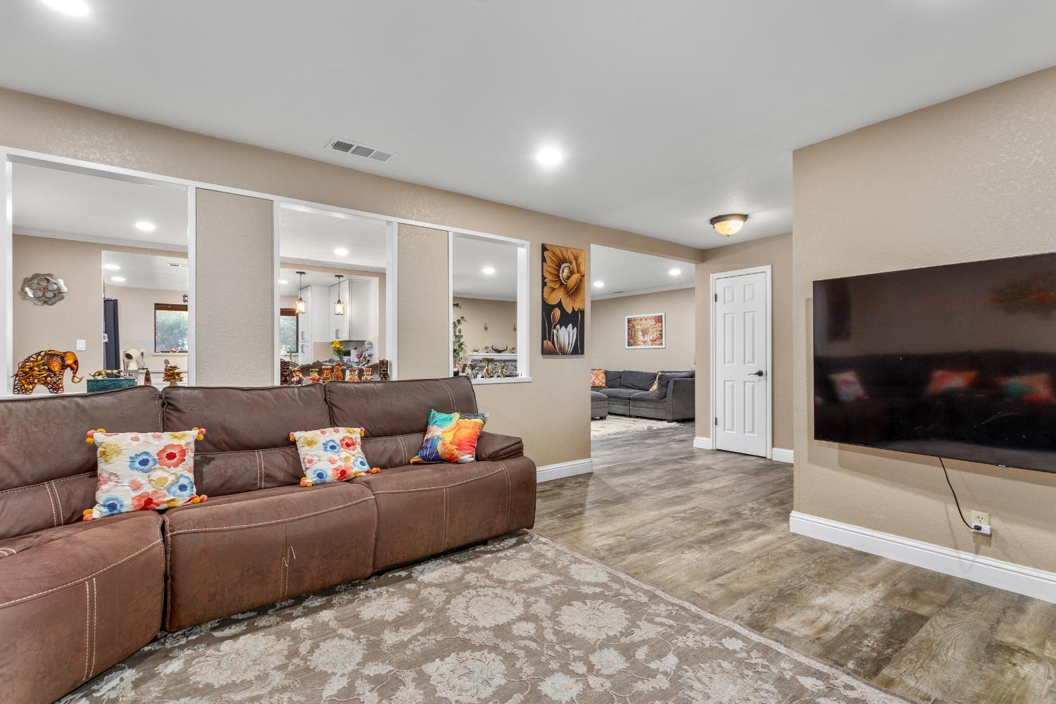 17188 Von Sosten Road Tracy, CA 95304 - Photo 4 of 39 a living room with furniture and a flat screen tv