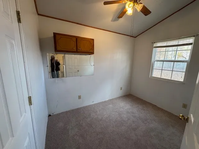 a view of a livingroom with an empty space and a window