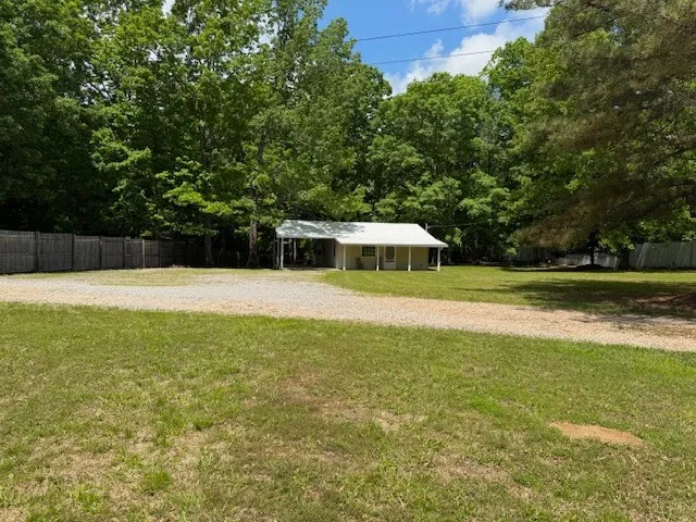 a view of a swimming pool with a yard