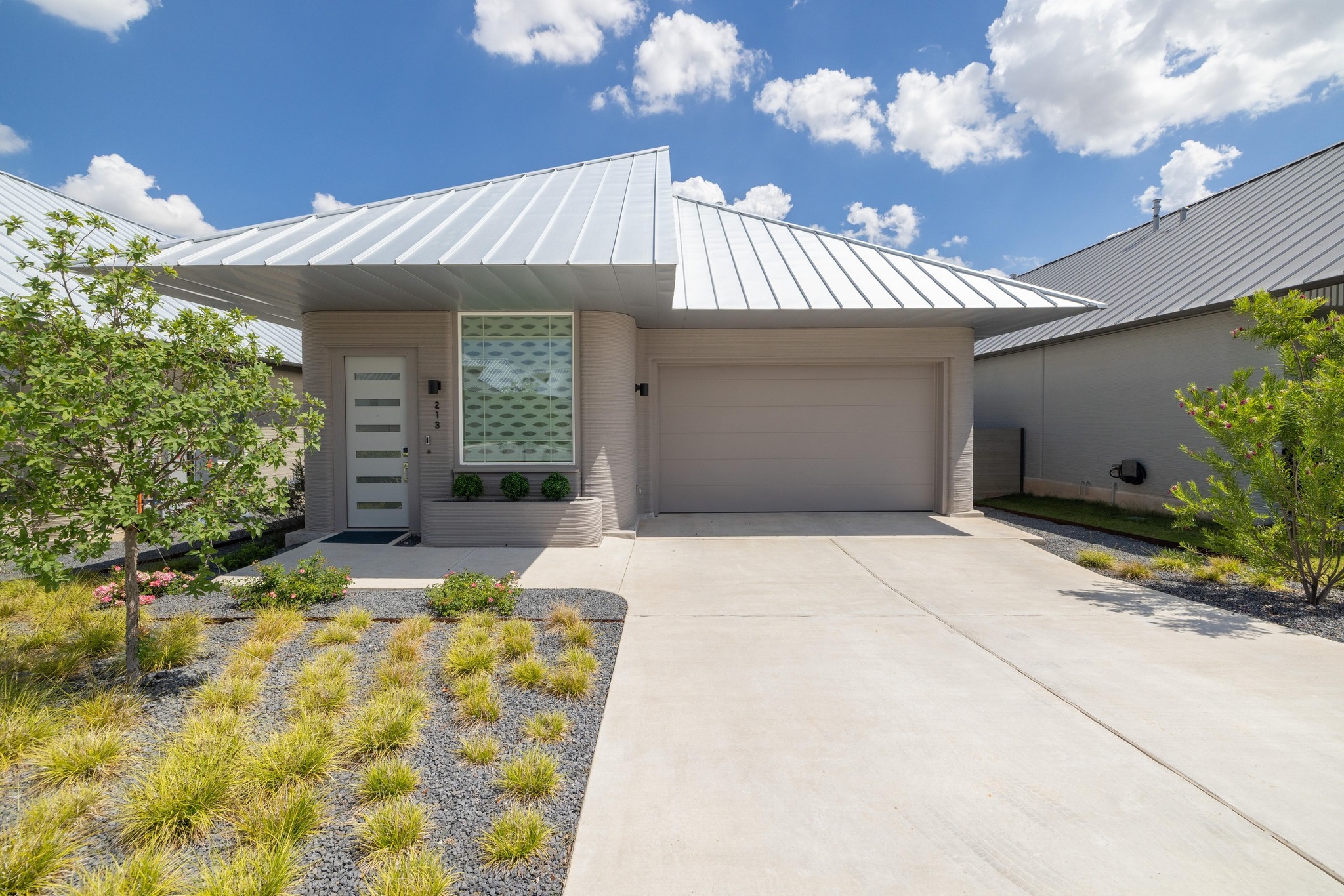 a front view of a house with garden