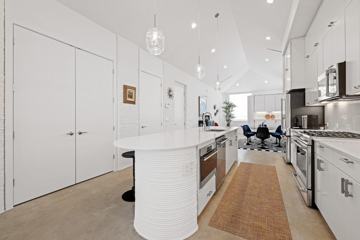 213 Lone Ranger Trail Georgetown, TX 78628 - Photo 12 of 26 a large kitchen with stainless steel appliances lots of counter space and a sink
