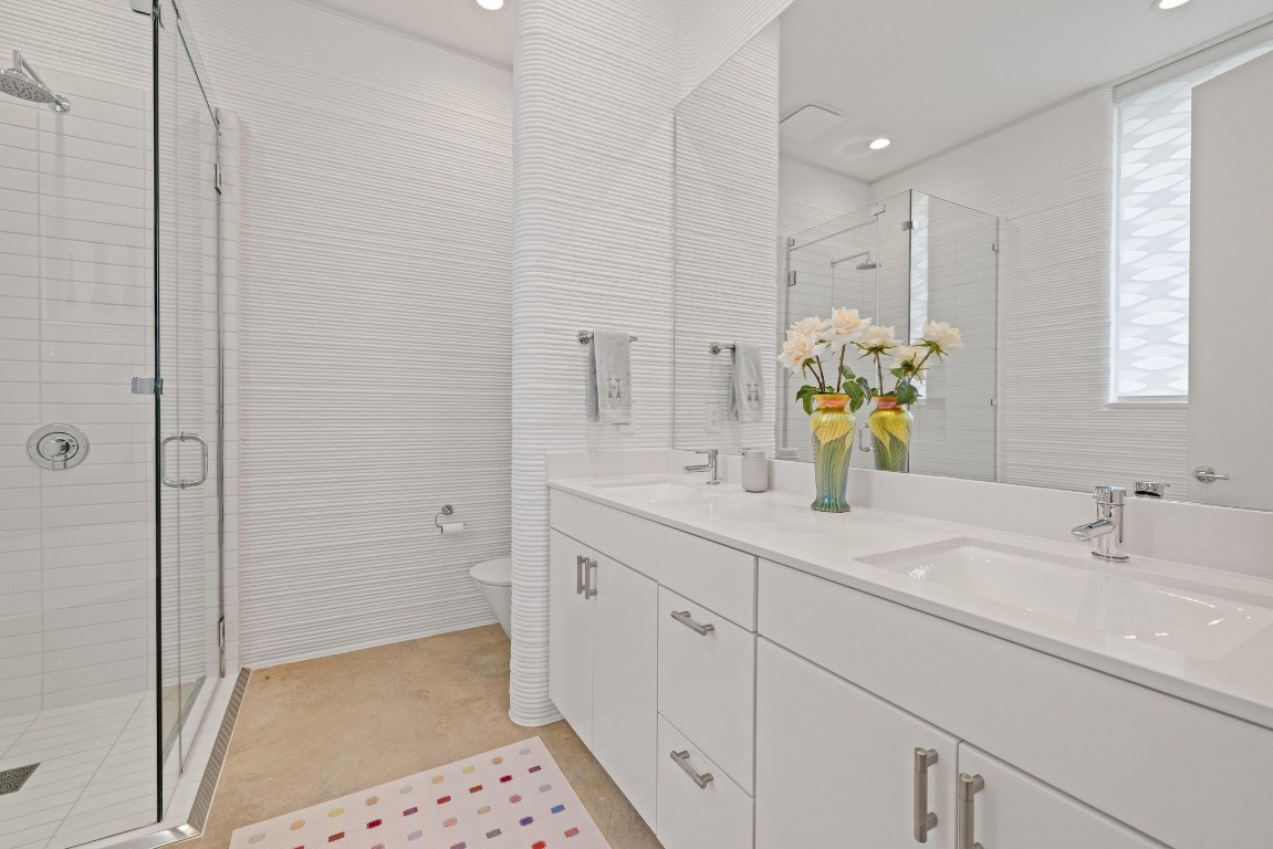 213 Lone Ranger Trail Georgetown, TX 78628 - Photo 17 of 26 a bathroom with a shower sink and mirror