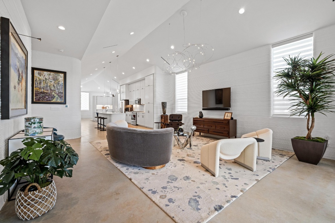213 Lone Ranger Trail Georgetown, TX 78628 - Photo 5 of 26 a living room with furniture a flat screen tv and a potted plant