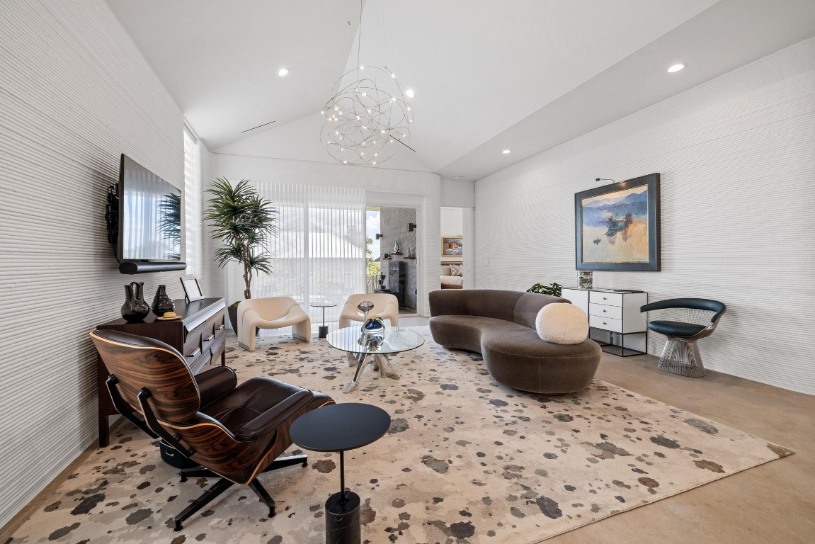 213 Lone Ranger Trail Georgetown, TX 78628 - Photo 7 of 26 a living room with furniture a rug and a chandelier